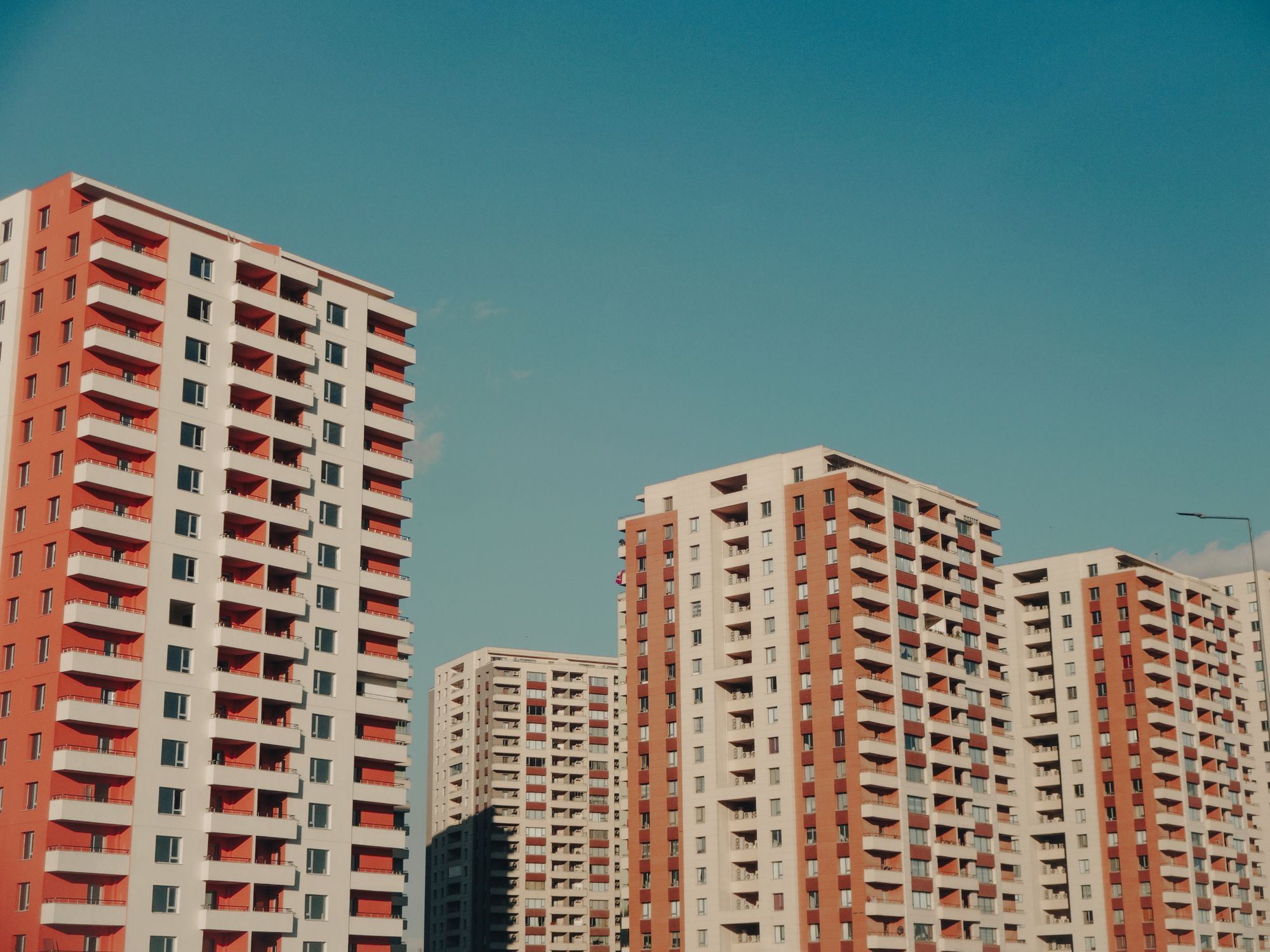 Captivating view of modern high-rise apartment buildings under a clear blue sky.