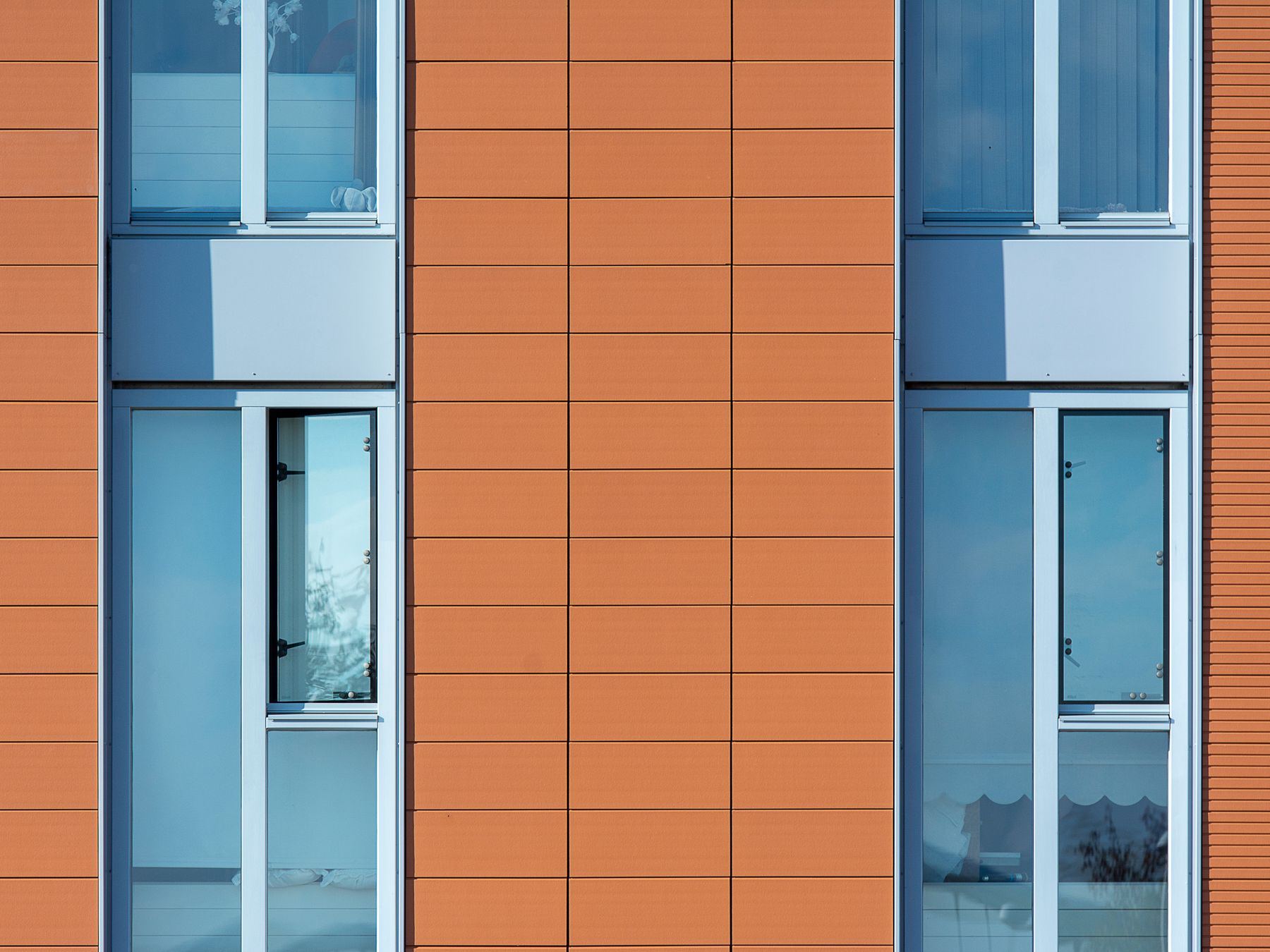 Close-up of a building facade featuring bold rectangular patterns and large windows.